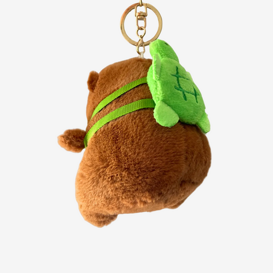 Plush keychain bear with green leaf on a white background