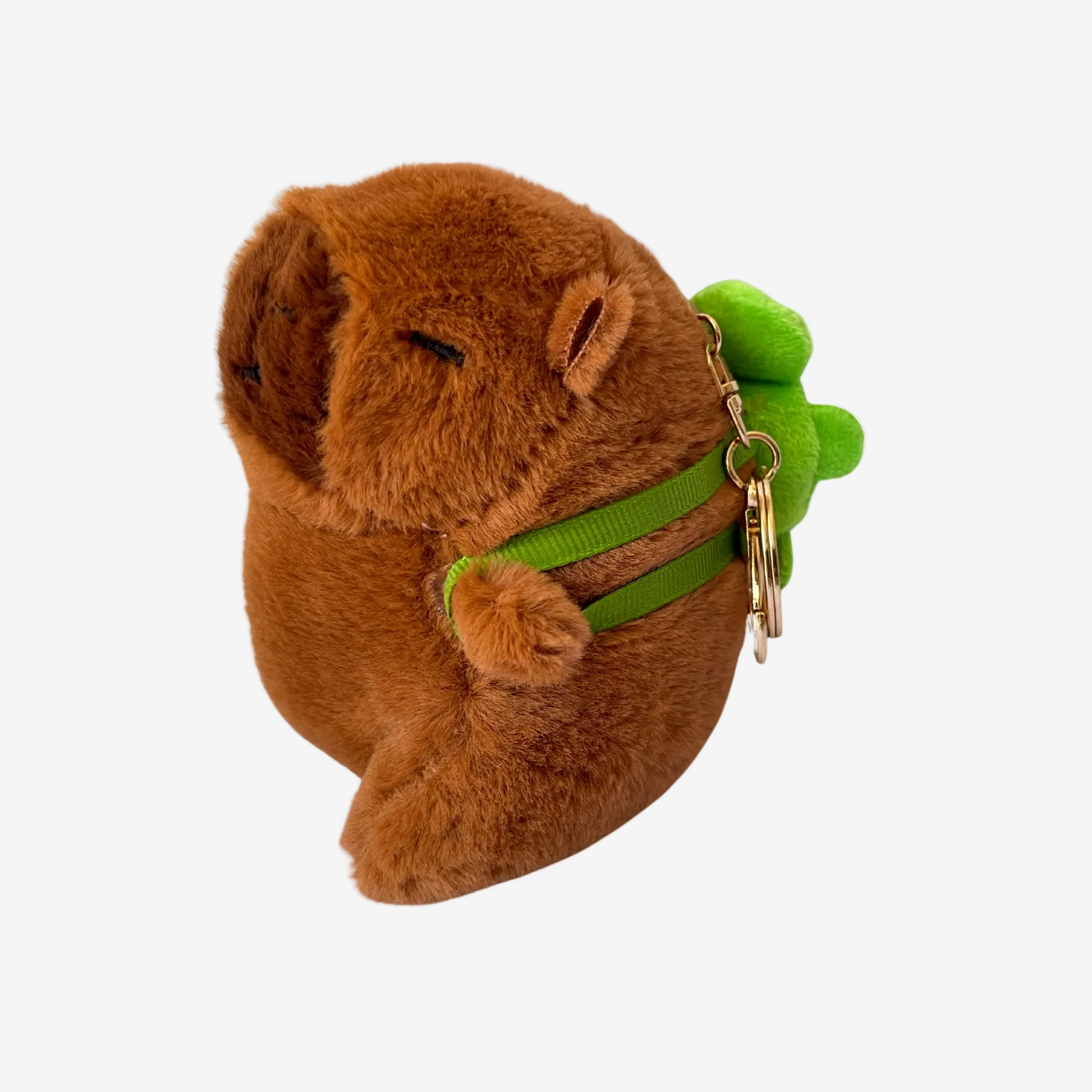 Brown plush dog toy with a green leash and keychain on a white background