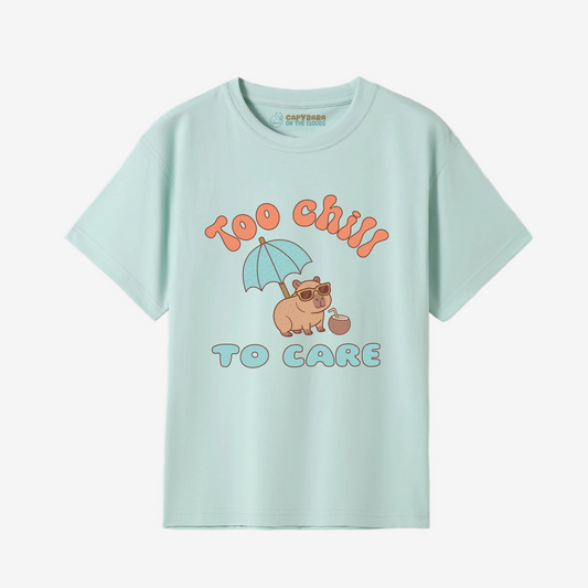 Light blue t-shirt with a graphic of capybara under an umbrella and text 'Too Chill To Care' on a white background.