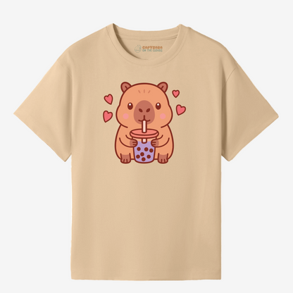 Beige t-shirt with a cartoon capybara drinking bubble tea design on a white background