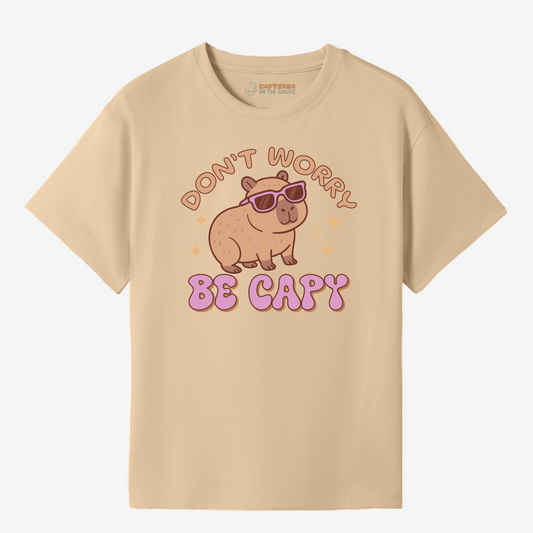 Beige t-shirt with a capybara graphic and text on a white background